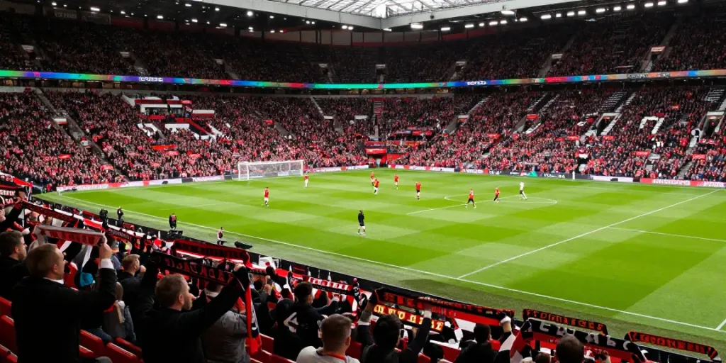 Exciting Manchester United vs Liverpool match atmosphere, showcasing fans and players in action.